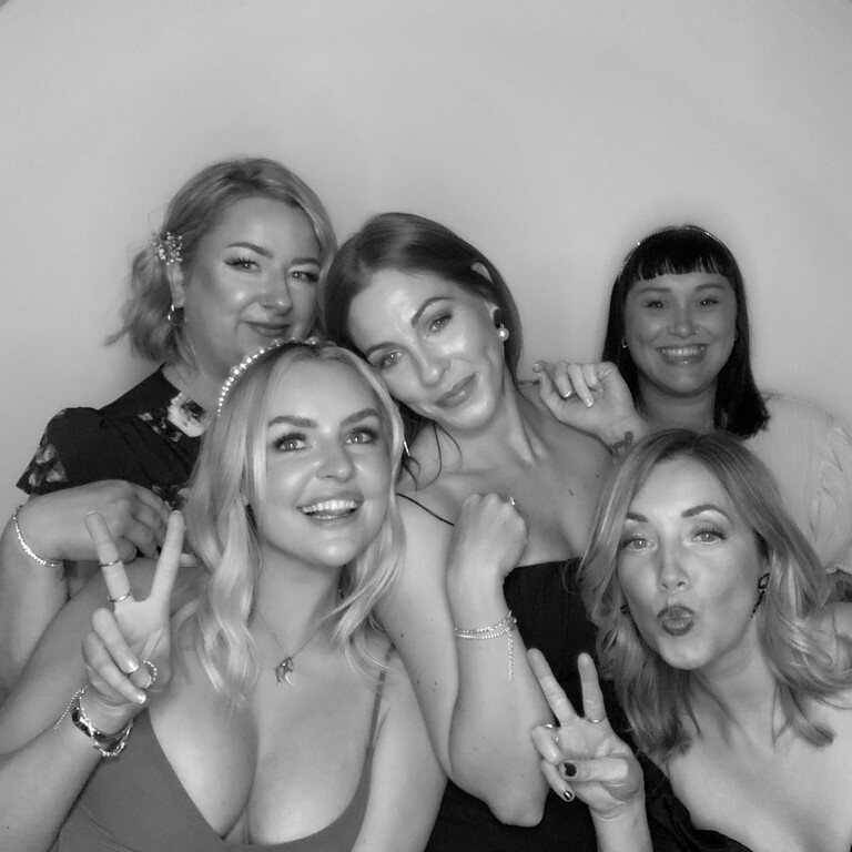 Group of guests posing for a Glam photo