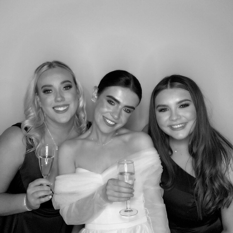 Three guests posing together for a black and white Glam photo