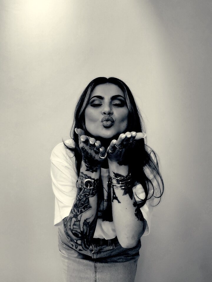 Guest blowing a kiss in a Glam photo booth portrait
