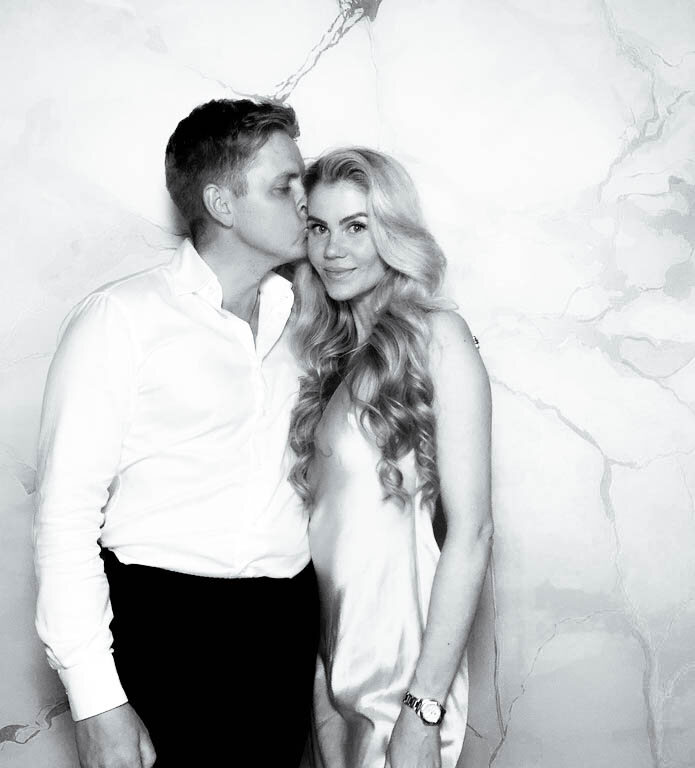 Couple at a wedding posing for a Glam photo